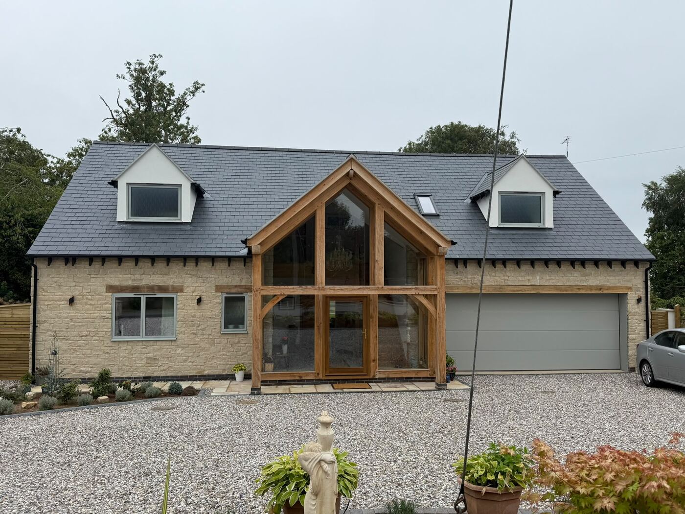 Oak-framed stone new build with natural slate roof, Ufton